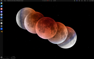 screenshot of desktop, showing a bunch of icons down the left, some small icons in the panel on top, and a picture from APOD on the desktop itself